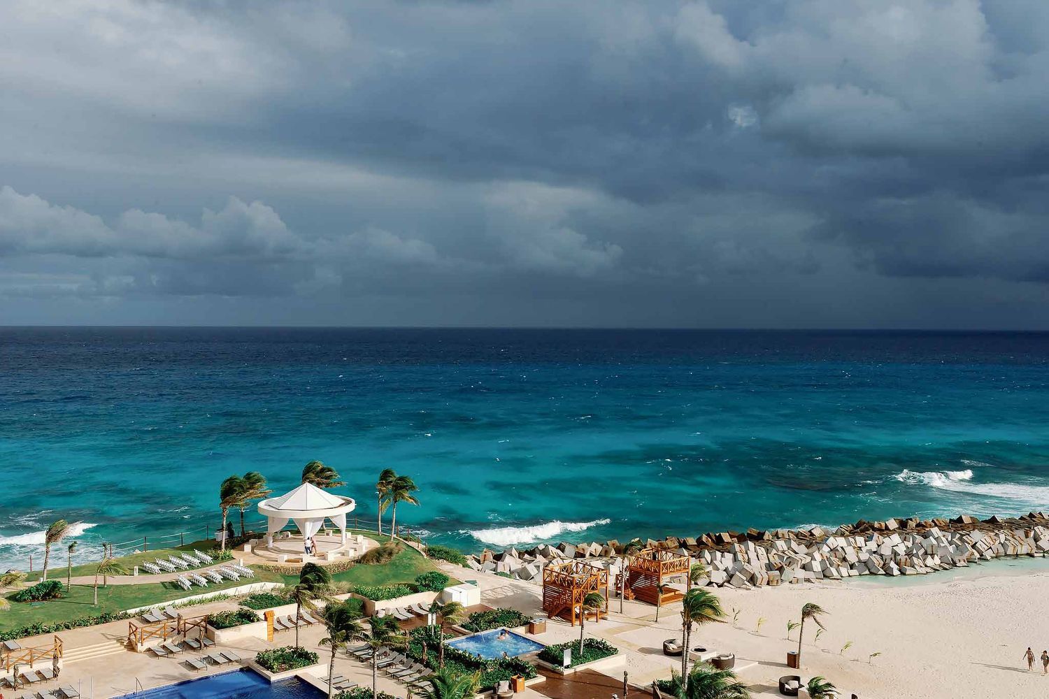 Panoramic Cancun oceanfront wedding venue with turquoise Caribbean waters and luxury beachfront ceremony setup in the Riviera Maya.