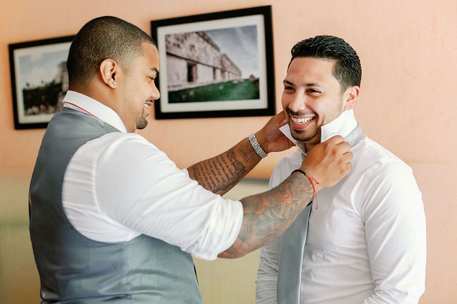 Keith smiles as a friend helps adjust his collar while getting ready at Sandos Playacar.