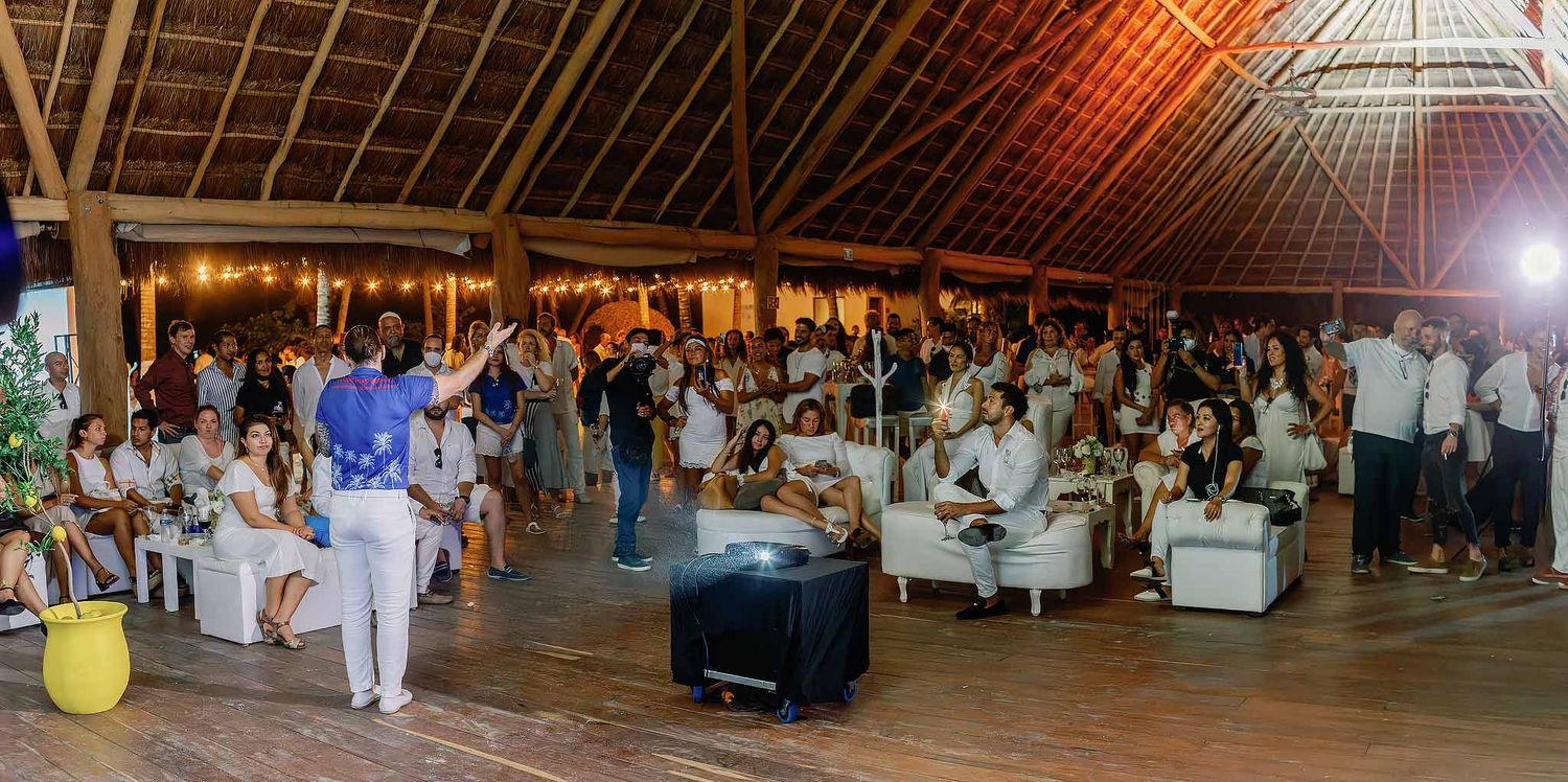 Corporate event photography Cancun showing speaker engaging audience during networking event at tropical venue