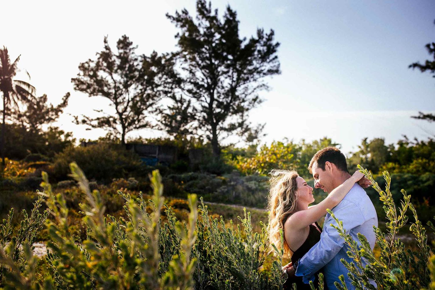 Romantic engagement portrait surrounded by tropical greenery in Punta Esmeralda Playa del Carmen.