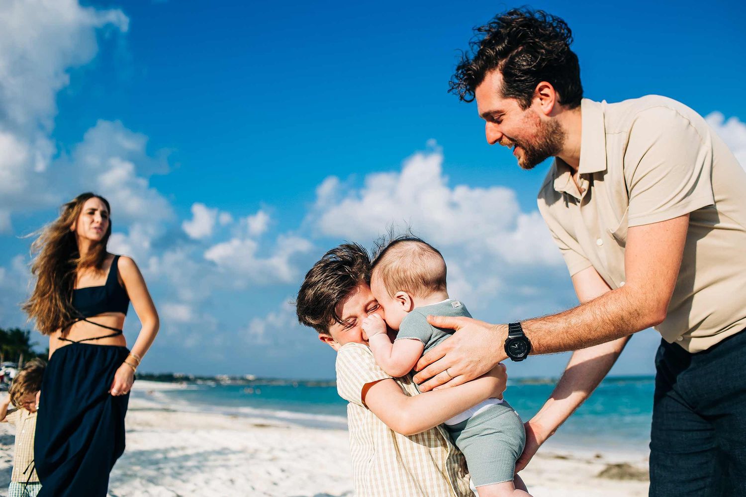 Older brother hugging his baby sibling during a candid family session at Fairmont Mayakoba in Riviera Maya.