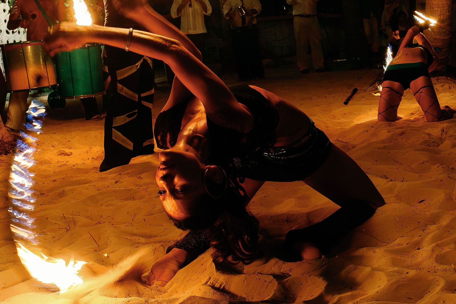 A fire dancer performs on the sand during the wedding reception at Fragata Beach Club.