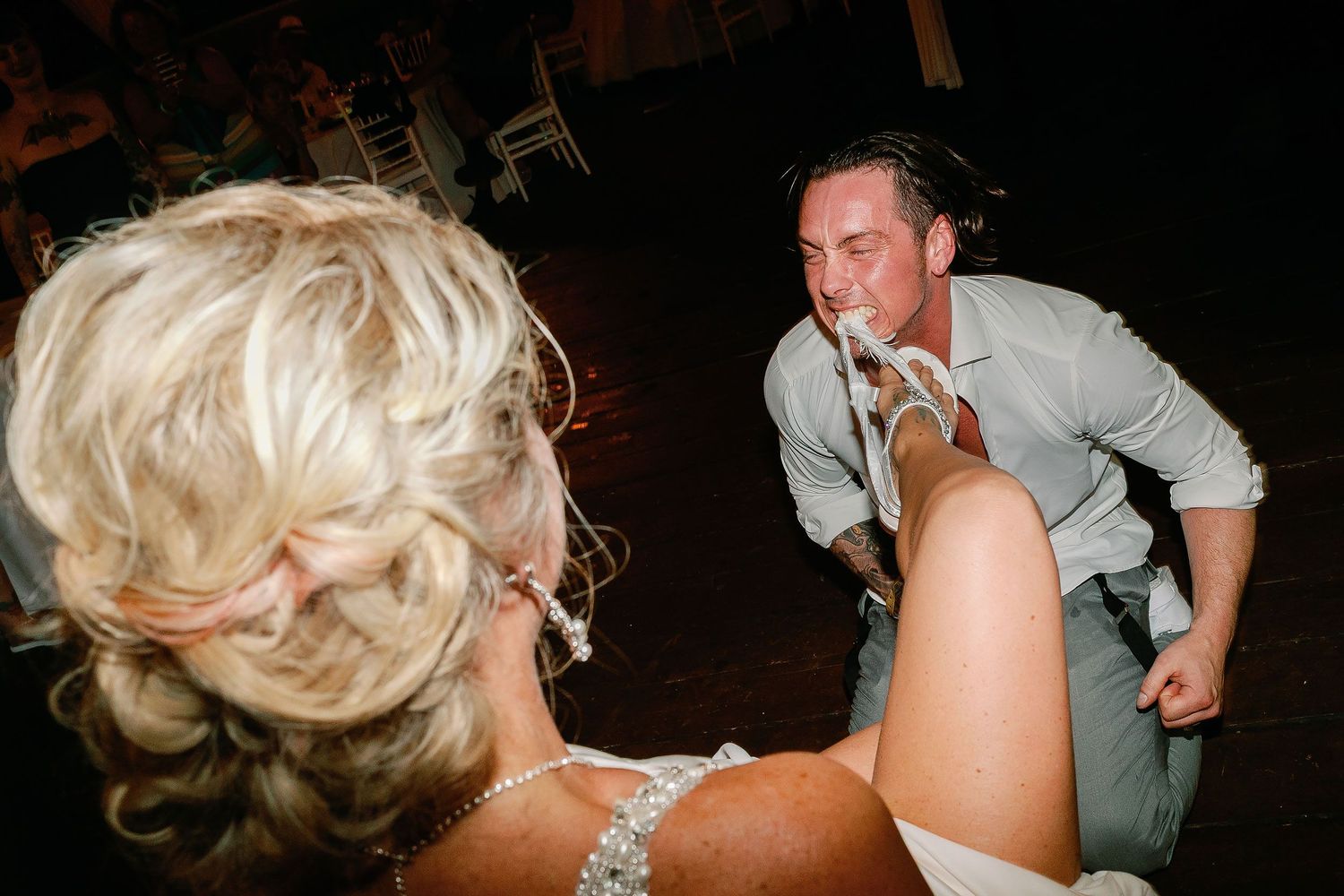 Scott playfully taking Carly’s garter during the wedding reception
