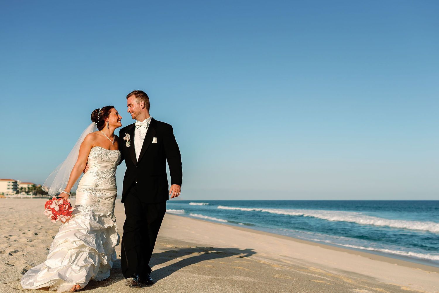 Elegant bride and groom portrait on the beachfront of Hyatt Ziva Los Cabos, one of the premier wedding resorts in Los Cabos.