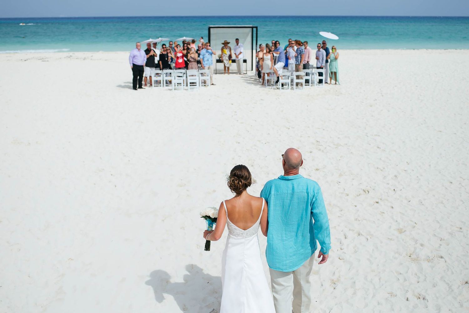 Grand beach wedding ceremony at Garza Blanca Resort & Spa Cancun. Professional photography services for destination weddings