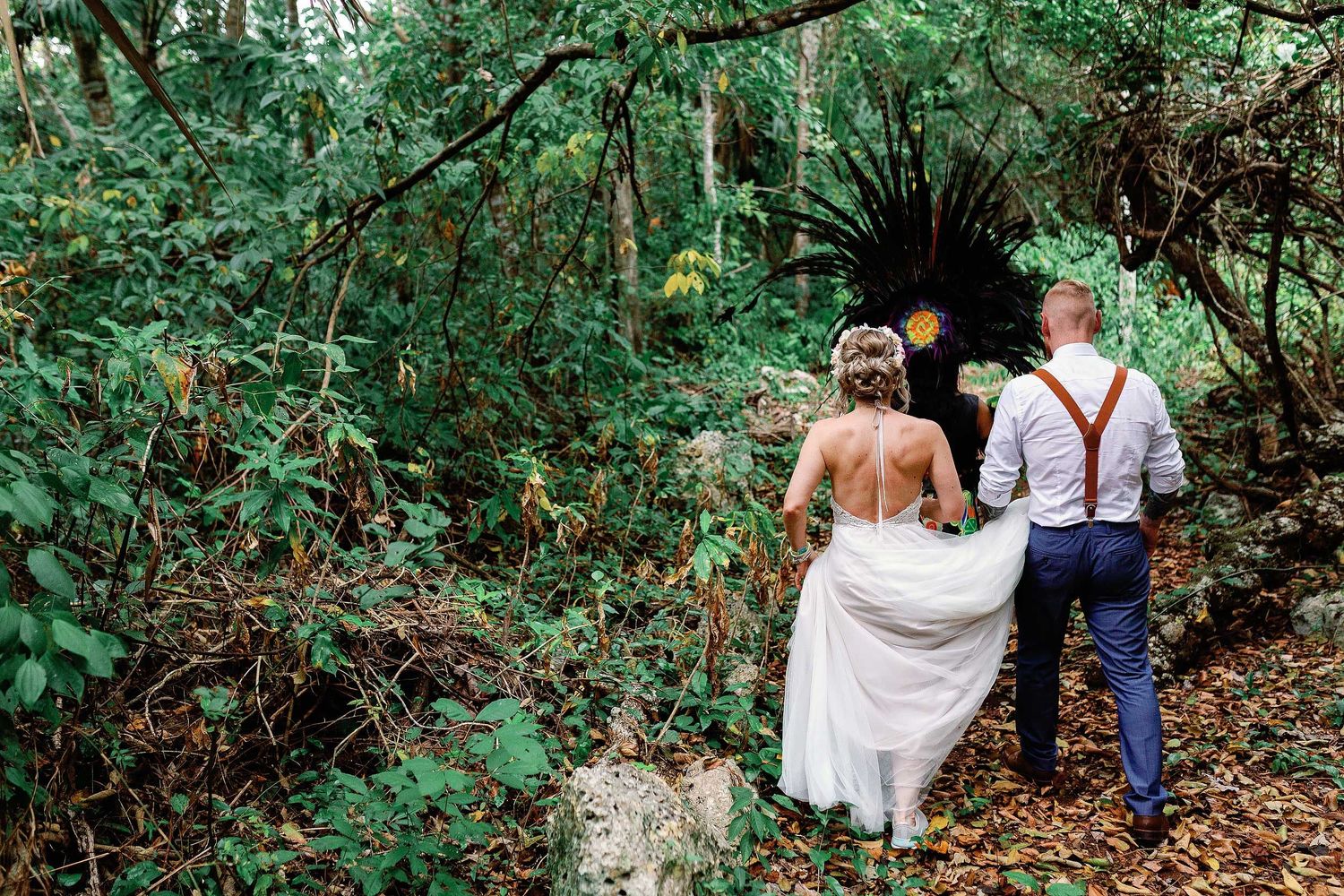 Jeff and Veronica walking through the Riviera Maya jungle toward their Maya wedding ceremony at Cenote Hats’uts near Playa del Carmen.