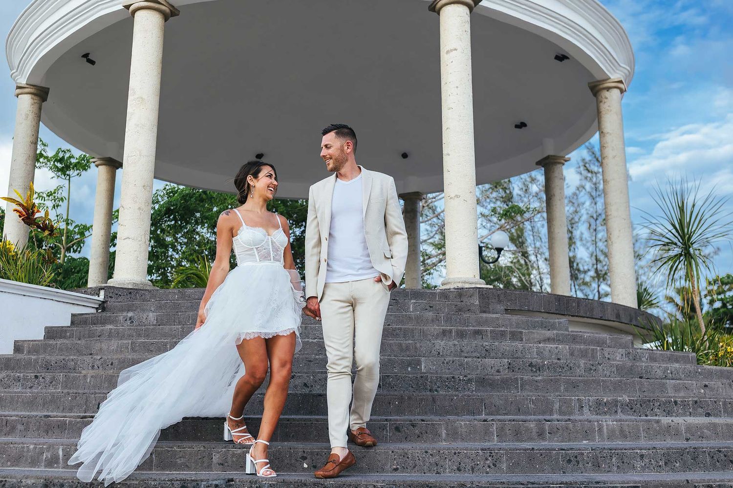 Couple walking during engagement session in Puerto Morelos Riviera Maya
