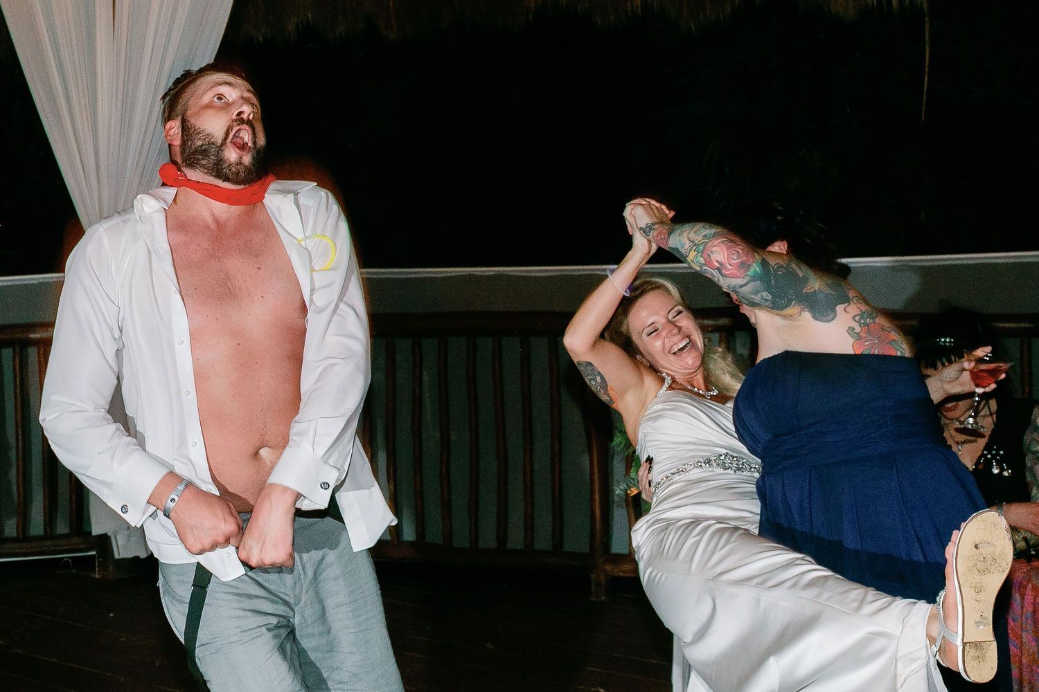 Carly laughing and dancing with guests at her Riviera Maya reception