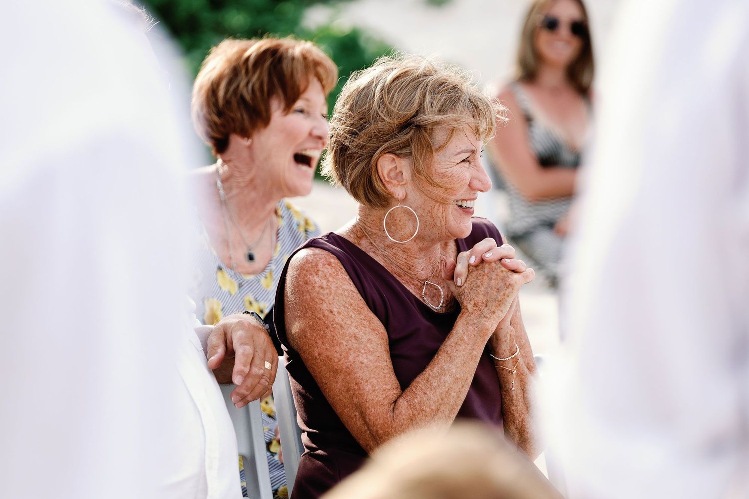 Wedding guests laughing during Autumn and Brian’s joyful oceanfront ceremony at Dreams Sapphire.