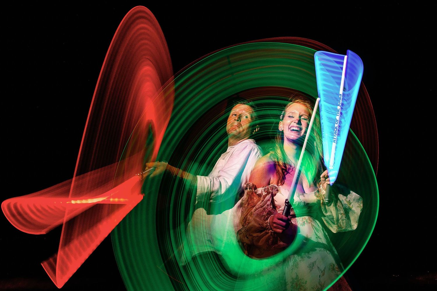 Creative night time wedding portrait of Autumn and Brian surrounded by colorful light-painting patterns at Dreams Sapphire.