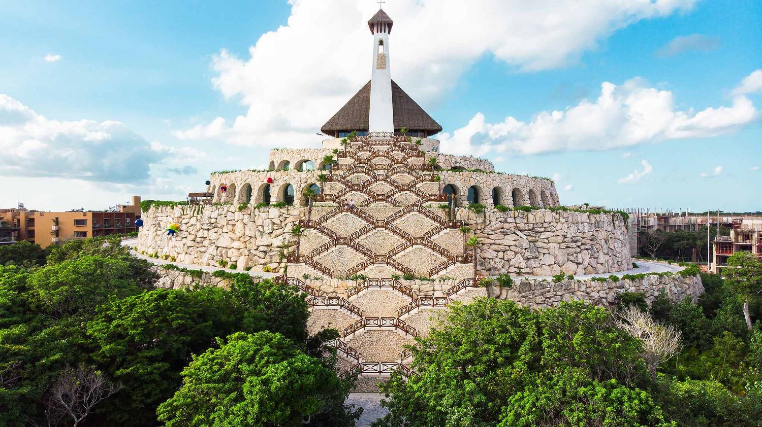Drone view of All Ángeles Chapel at Hotel Xcaret Mexico, iconic Catholic wedding venue in Riviera Maya surrounded by jungle