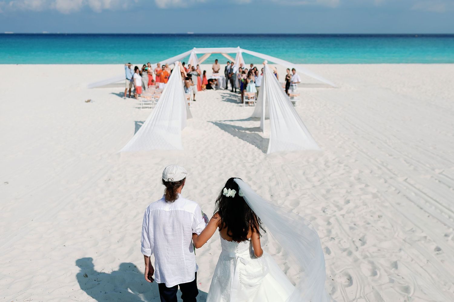 Felicitas approaches her beach ceremony beside the turquoise Caribbean Sea.