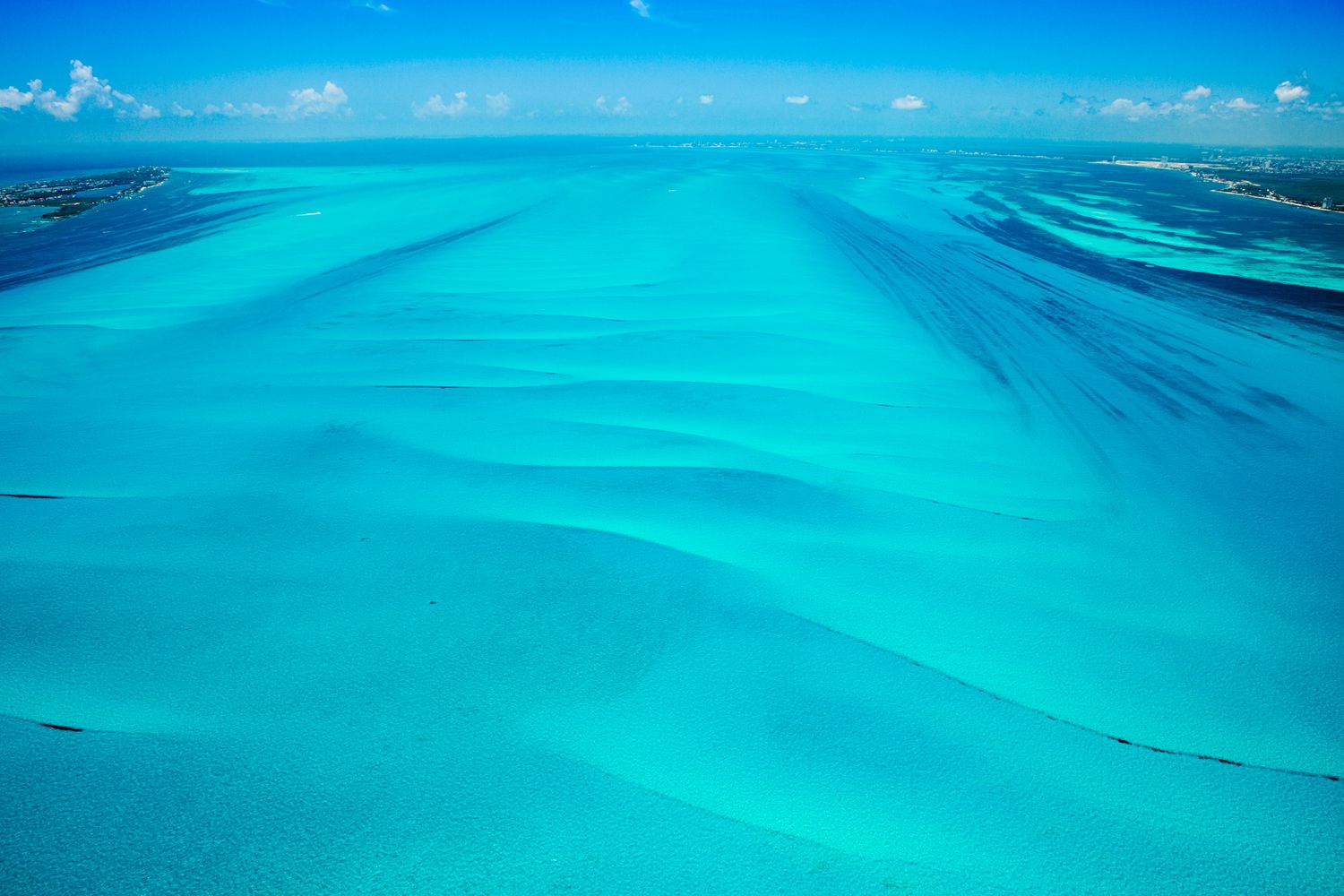 Aerial view of the turquoise Cancun ocean and hotel zone. Perfect inspiration for couples planning a destination wedding in Mexico