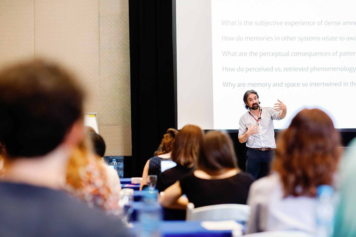 Corporate event photography Cancun showing speaker presenting during conference session to audience in meeting room
