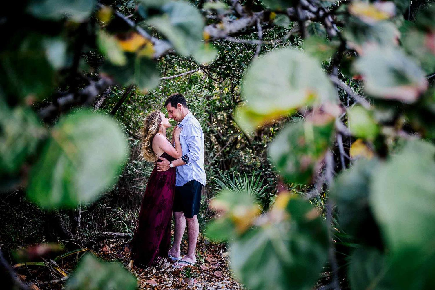 Romantic engagement photo surrounded by tropical trees and natural scenery in Punta Esmeralda Riviera Maya.