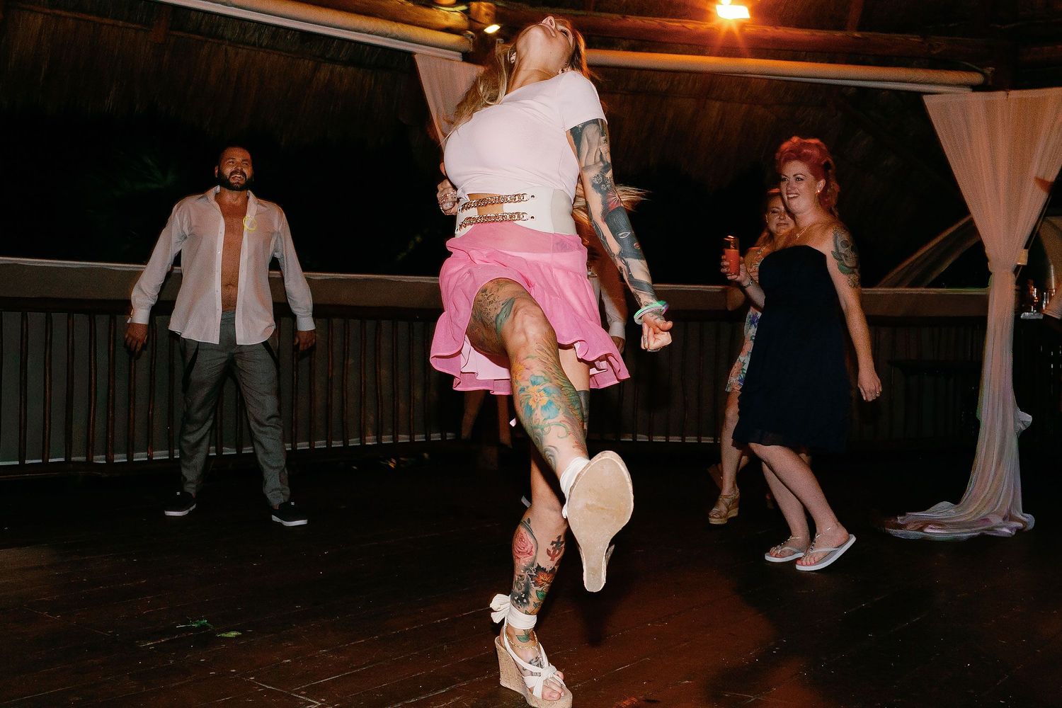 Wedding guest dancing during Carly and Scott’s oceanfront palapa reception