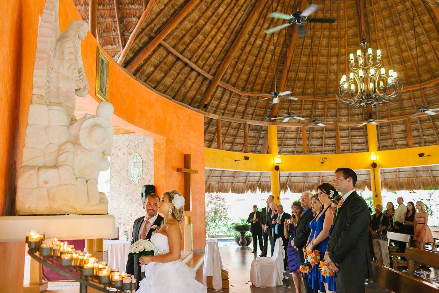Catholic wedding ceremony at Our Lady of Guadalupe Chapel Barceló Riviera Maya with bride and groom at altar and guests inside