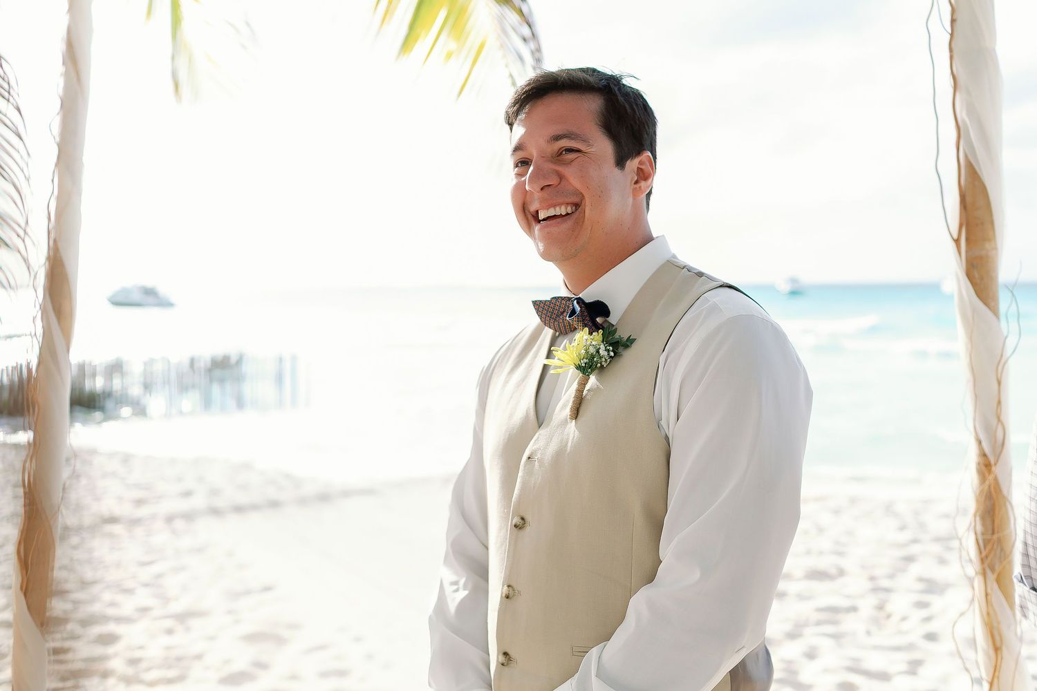 Carlos laughs beneath the ceremony canopy while waiting on the beach at Playa Norte.