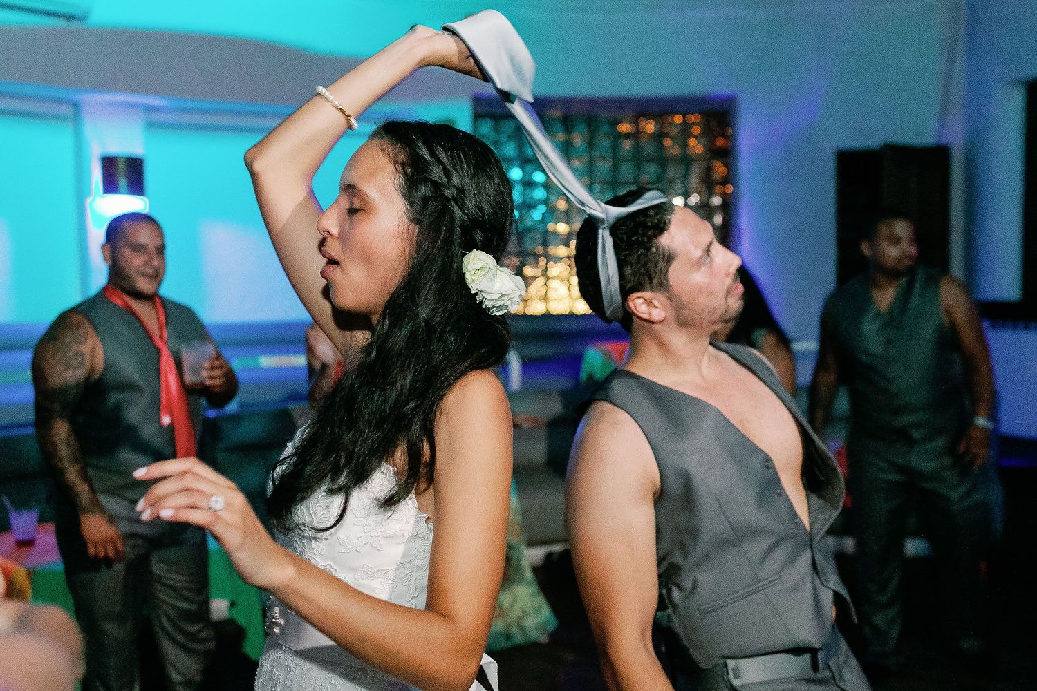 Felicitas waves a silver tie while dancing at her Sandos Playacar reception.