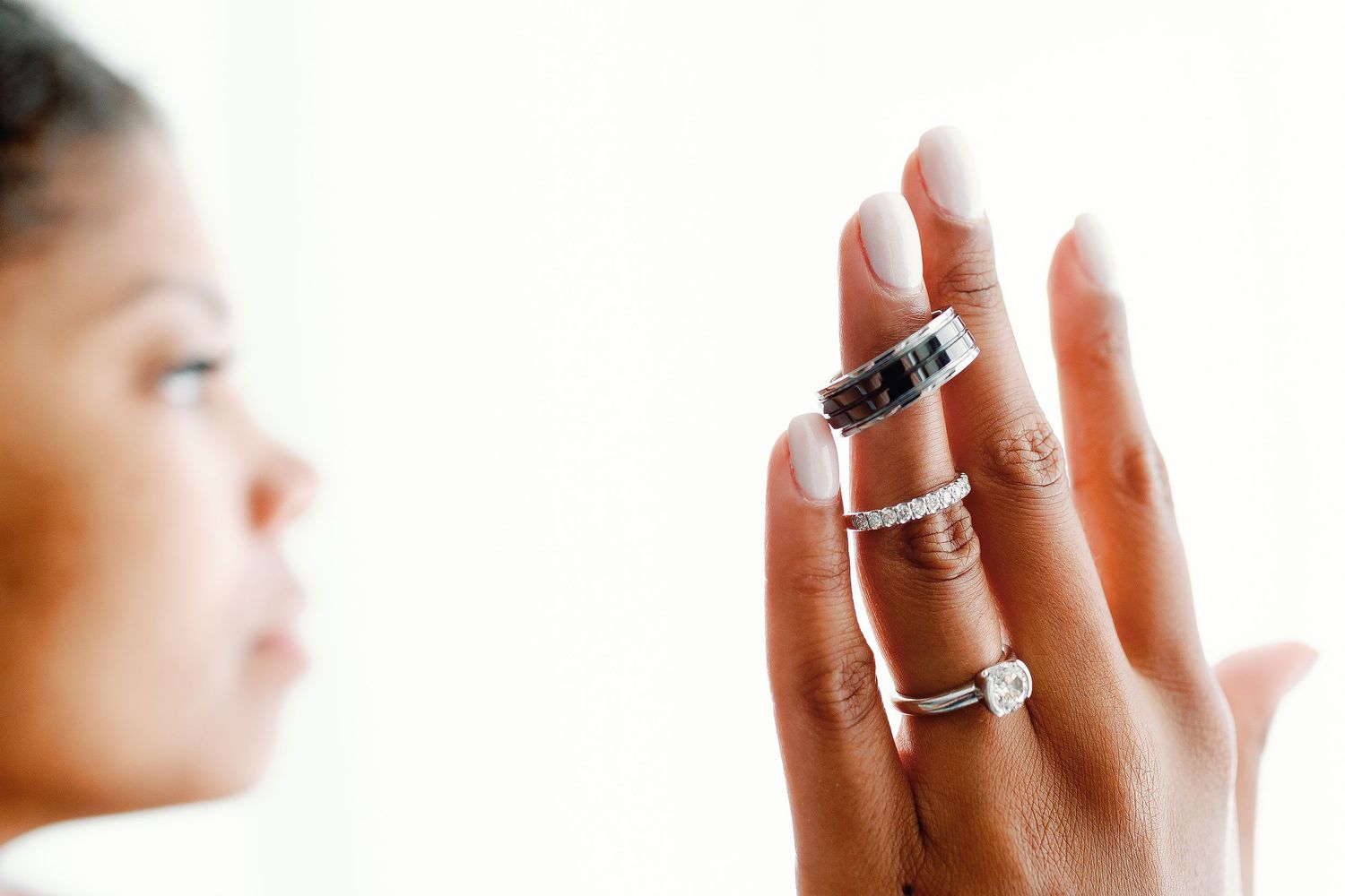 Close-up of the bride displaying the couple’s wedding rings on her hand at Excellence Riviera Cancun.