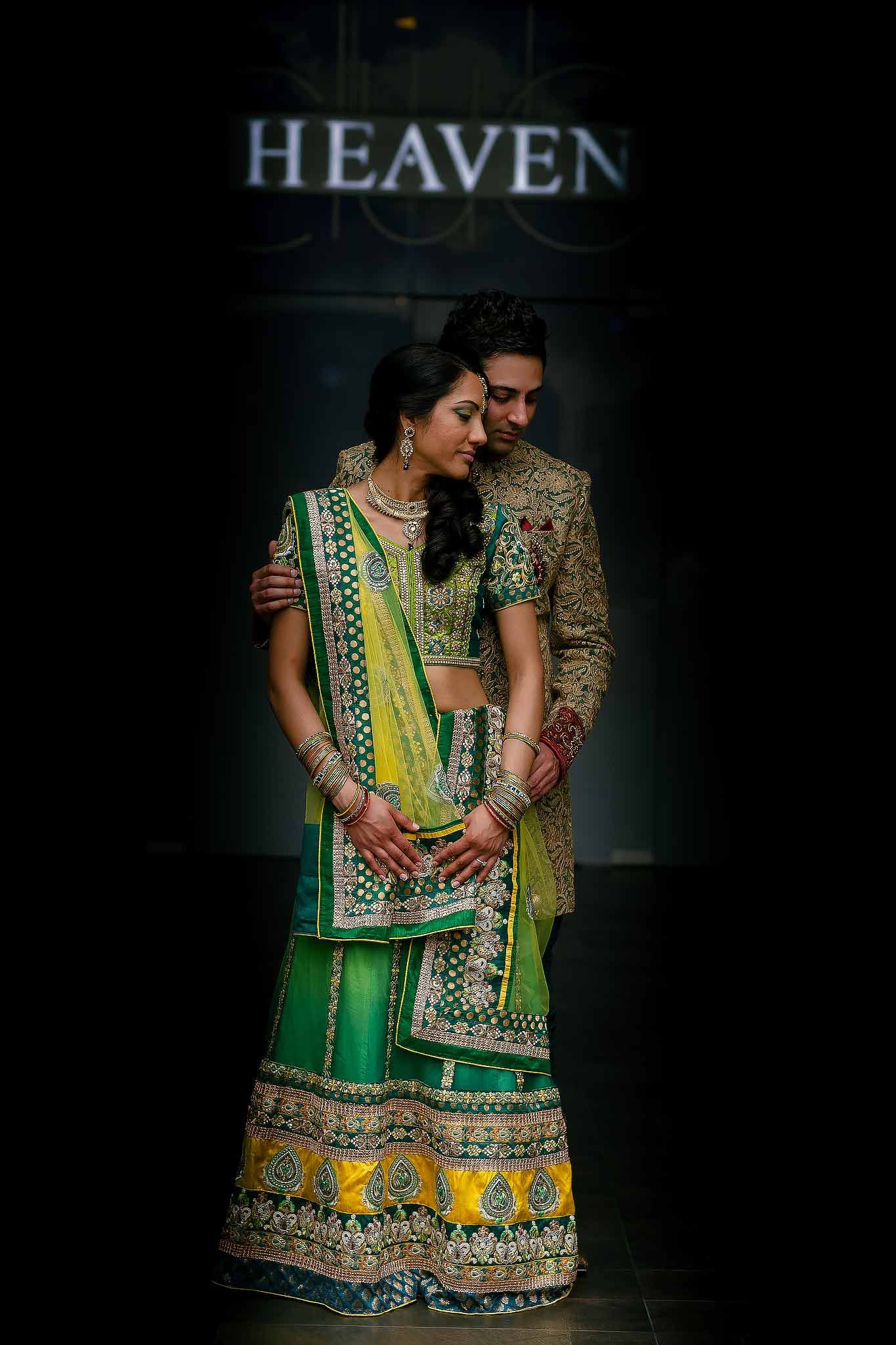 Elegant Indian Hindu wedding couple portrait in Riviera Maya featuring bride in green lehenga and groom in embroidered sherwani during desti