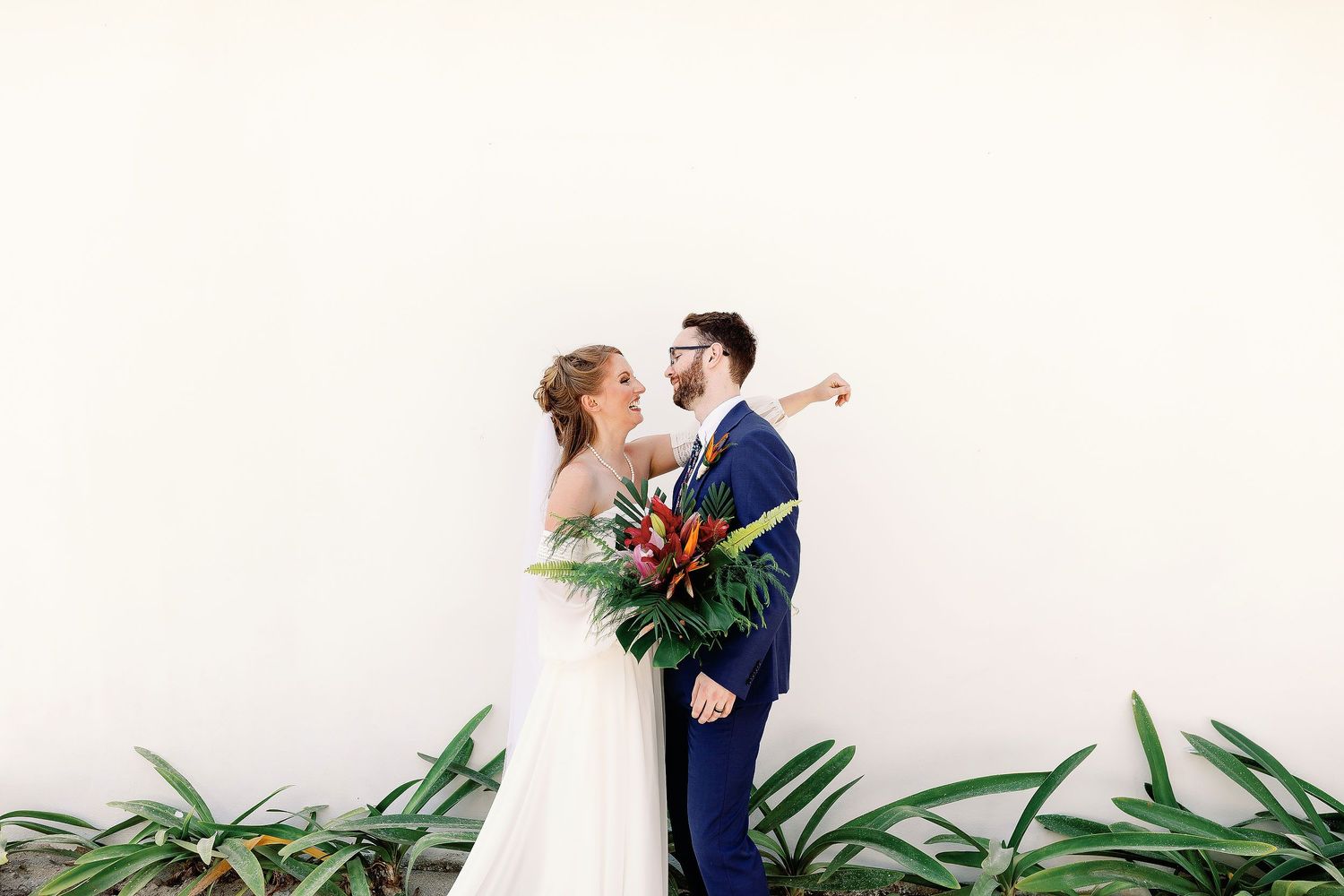 Nicole and Thomas smiling together during a minimalist wedding portrait at Blue Venado in Playa del Carmen.