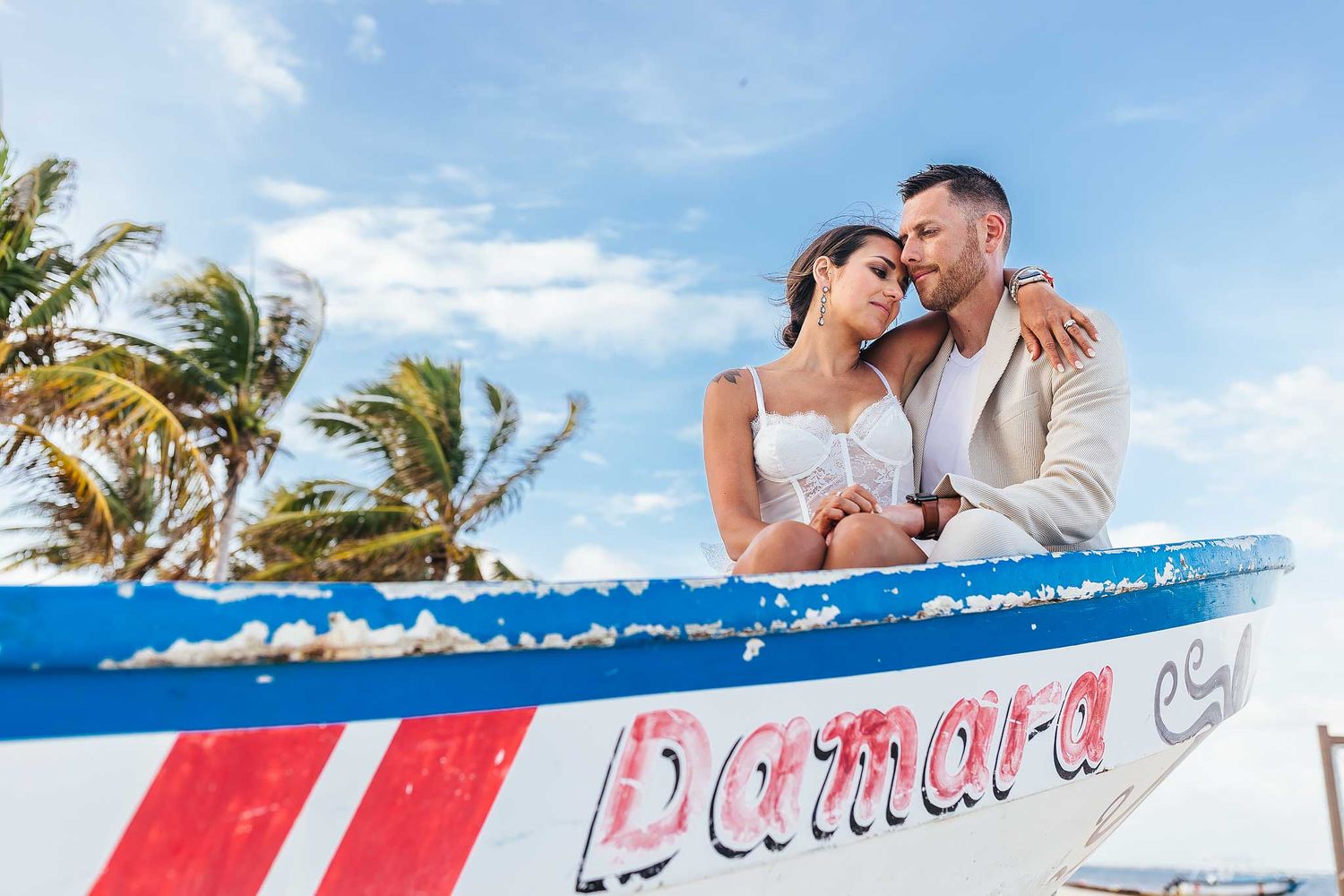 Romantic couples portrait on a fishing boat in Puerto Morelos Riviera Maya
