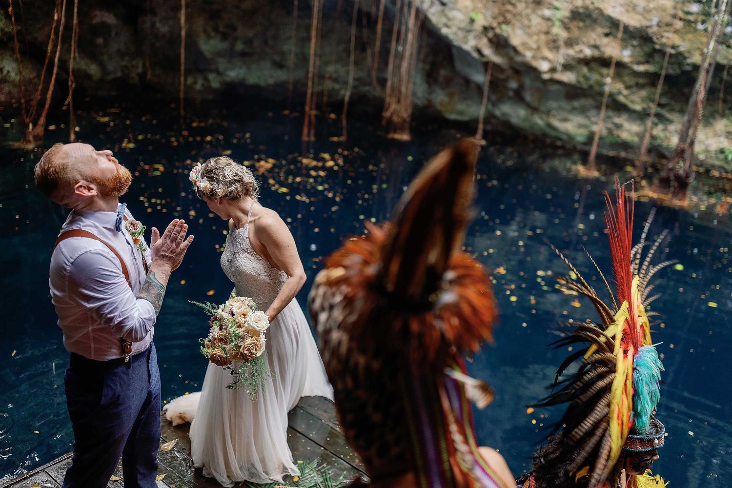 Jeff and Veronica taking part in a Maya wedding ceremony beside the blue water of Cenote Hats’uts near Playa del Carmen.