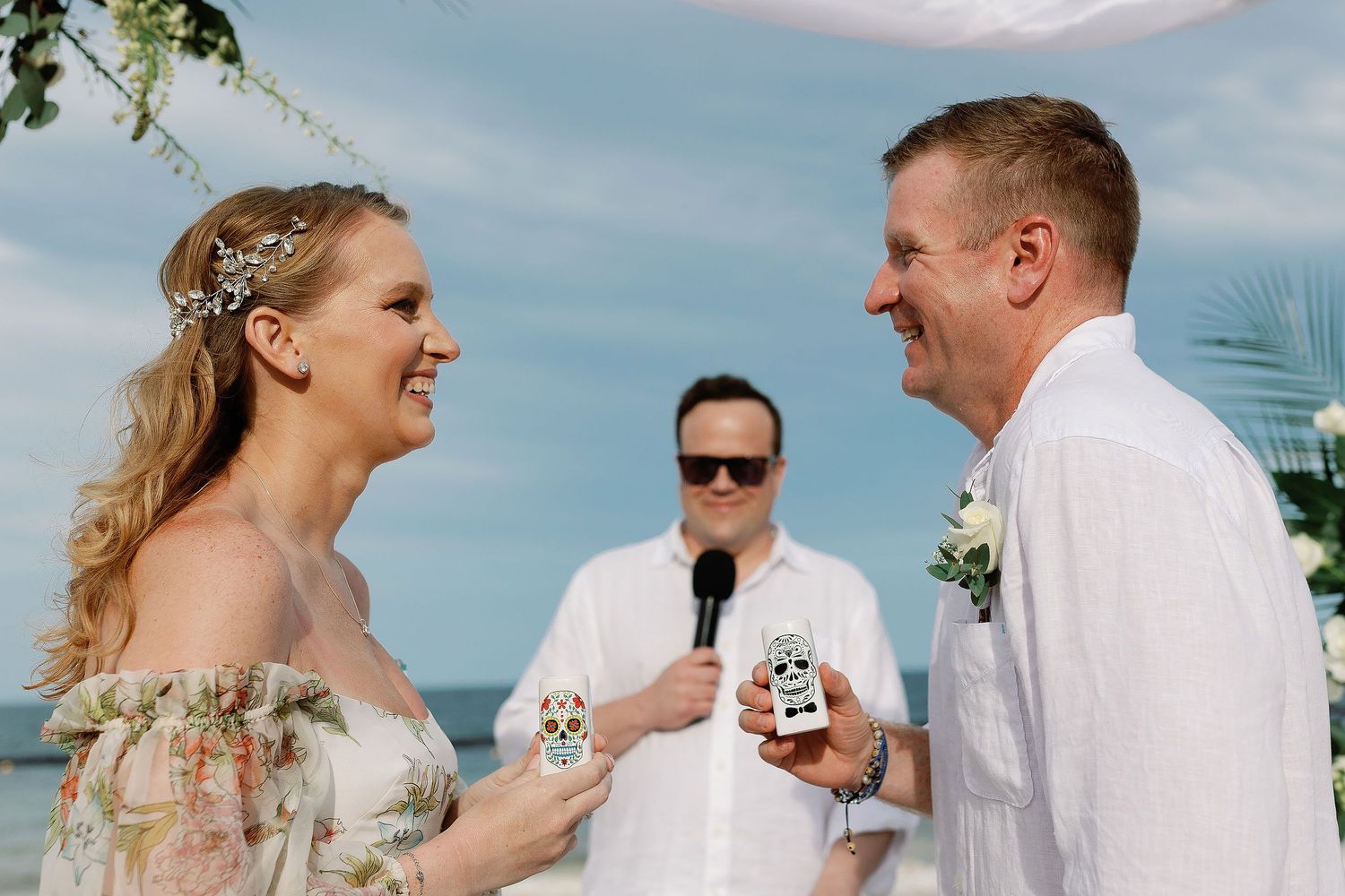 Autumn and Brian sharing a tequila toast during their relaxed beach wedding ceremony at Dreams Sapphire in Puerto Morelos.