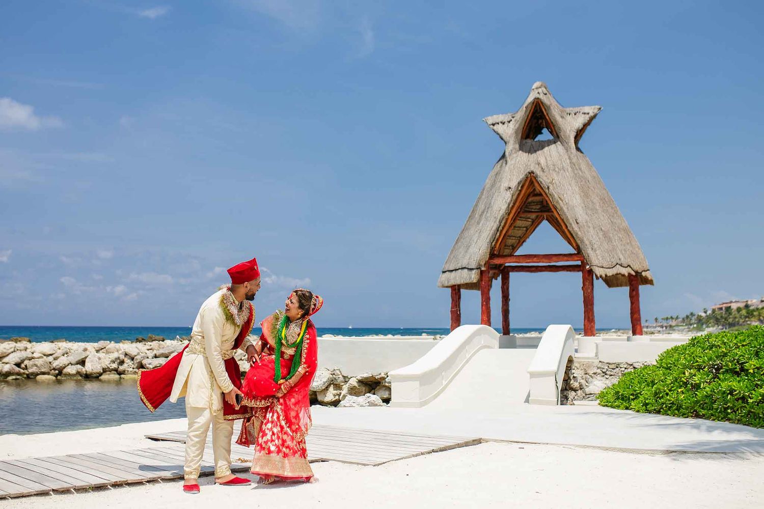 Indian wedding couple portrait at Dreams Aventuras Riviera Maya with oceanfront scenery and traditional Hindu attire.