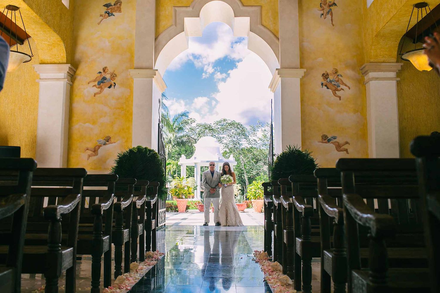 Bride with father walking down aisle at Our Lady of the Snows Chapel, Grand Palladium Riviera Maya—Catholic wedding near Cancun