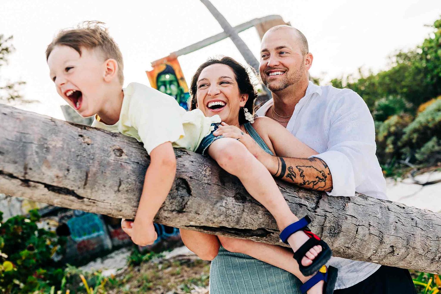 Candid family moment captured near a rustic beach structure in Playa del Carmen