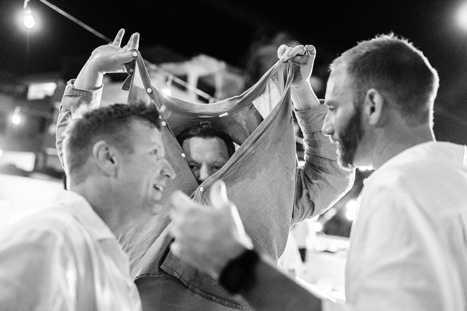 Wedding guests sharing a playful moment on the dance floor during Autumn and Brian’s beach reception.