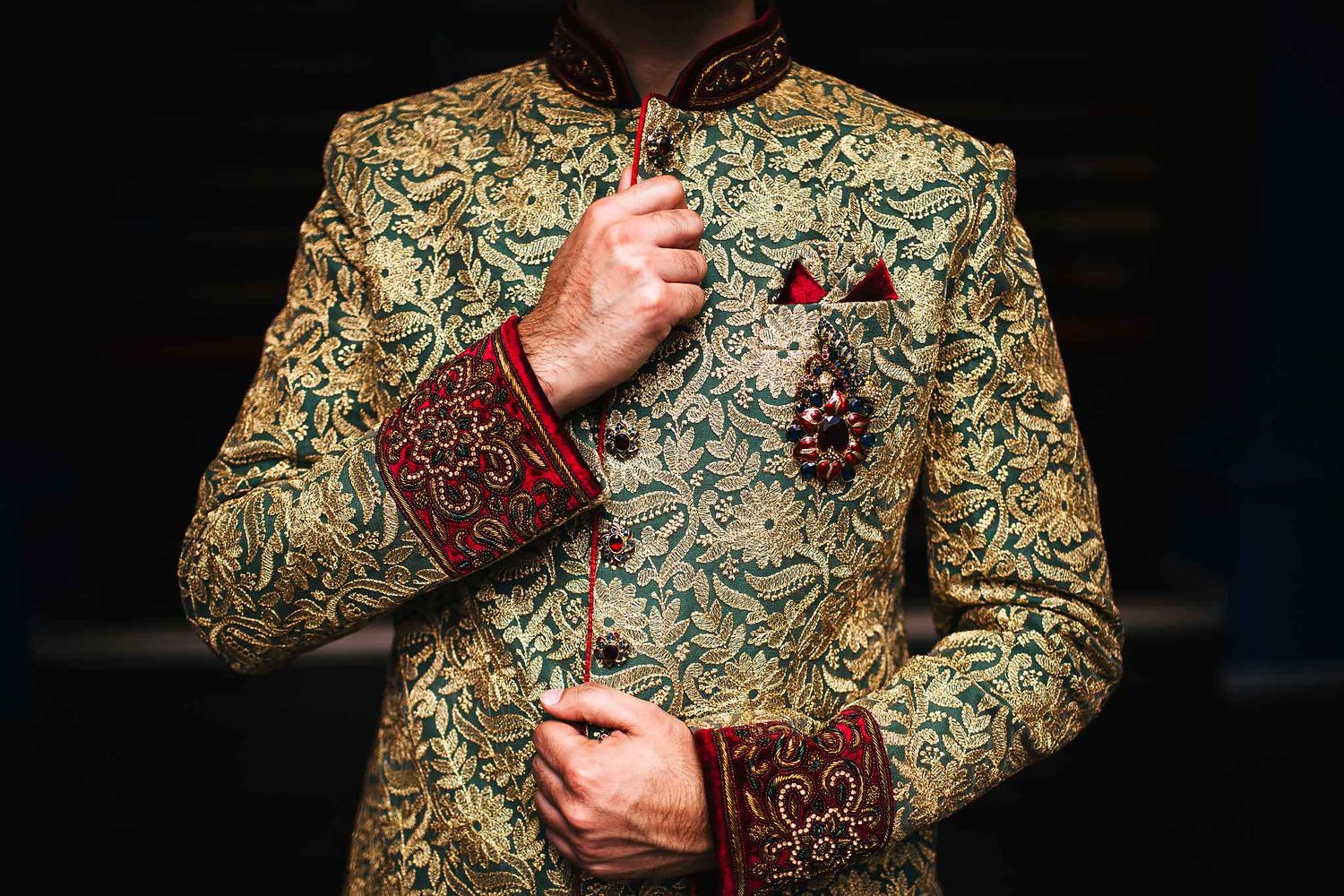 Close-up of luxury Indian groom sherwani with intricate gold embroidery and traditional wedding details at Barcelo Riviera Maya destination