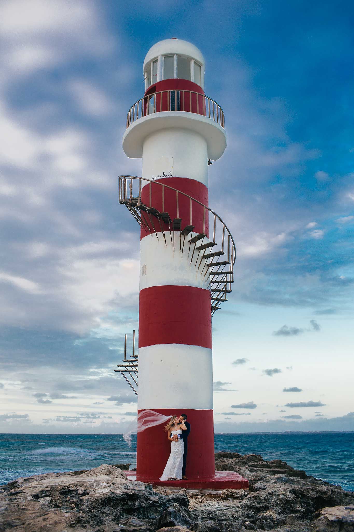 Destination wedding photo session at Punta Cancun Lighthouse. Professional photography services in Hyatt Ziva Cancun