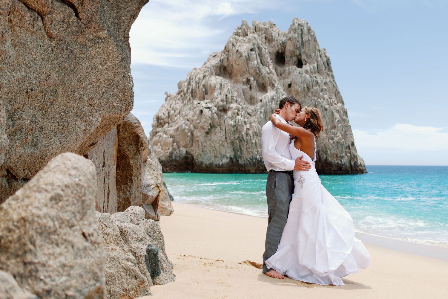 Luxury wedding portrait captured near the iconic Los Cabos Arch, showcasing the natural beauty of Cabo San Lucas and Baja California Sur.
