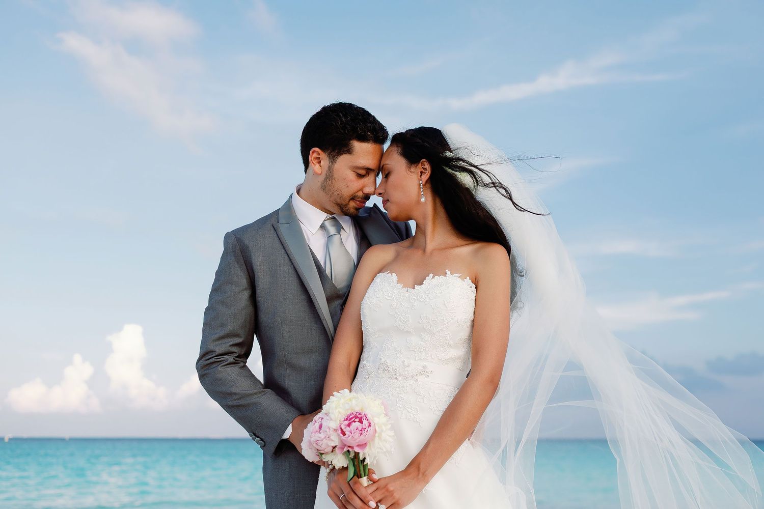 Felicitas and Keith lean close during an intimate portrait beside the Caribbean Sea.