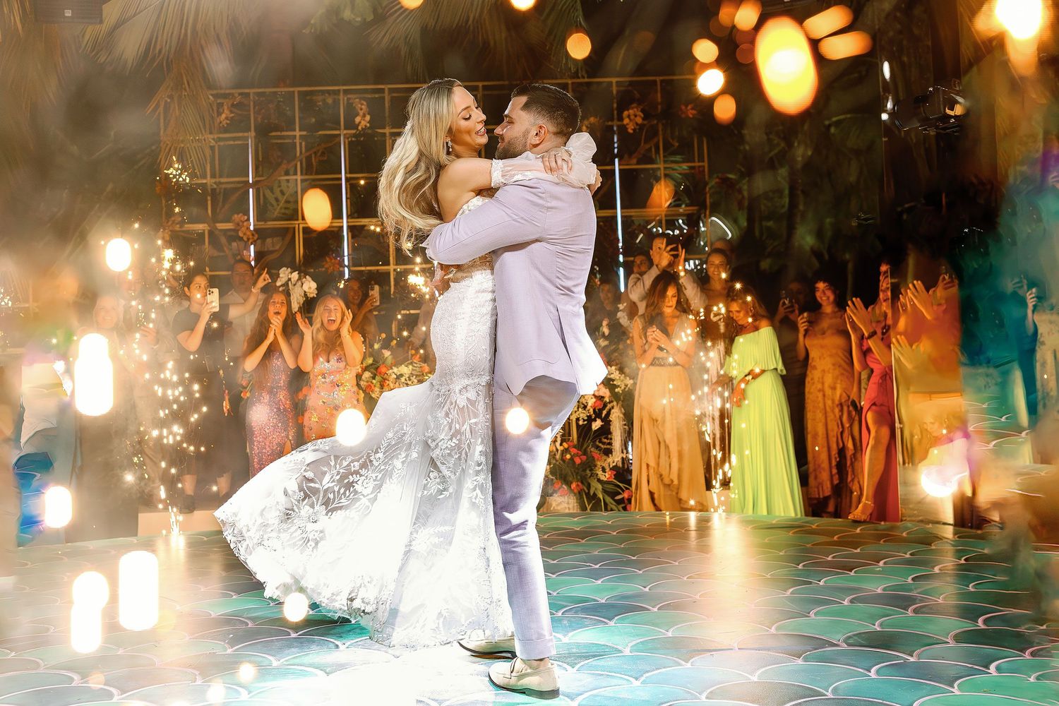 Bride and groom sharing their first dance surrounded by sparklers and guests during a luxury wedding reception at W Punta de Mita, Puerto Va
