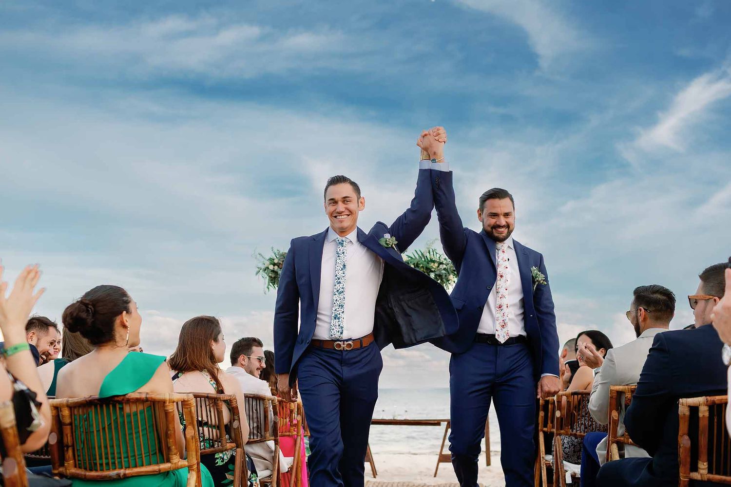 Joyful gay wedding ceremony in Playa del Carmen featuring a beachfront celebration and destination wedding photography.