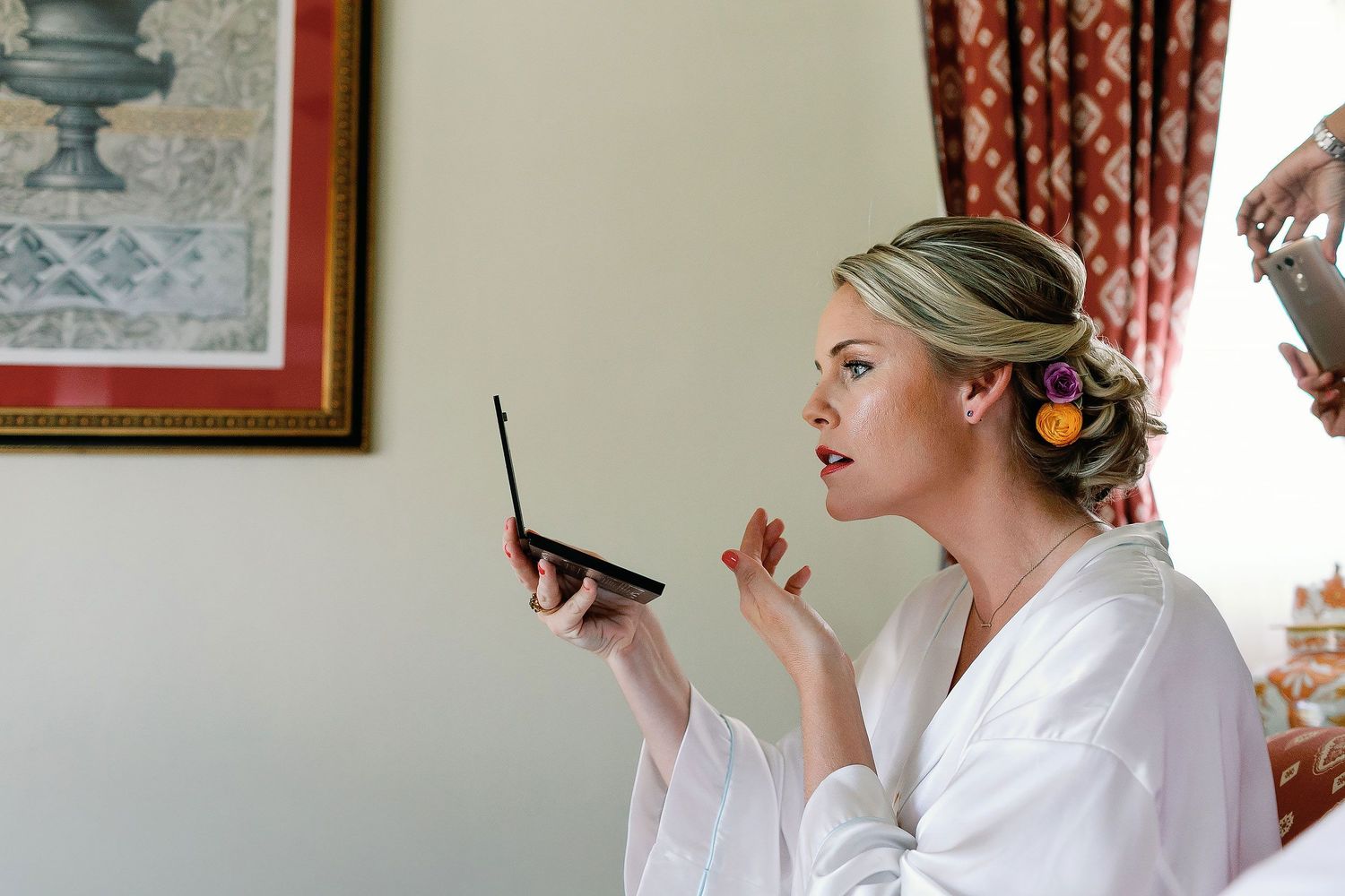 Cressida checks the final touches of her bridal makeup while preparing at Riu Palace Riviera Maya in Playacar, Playa del Carmen.