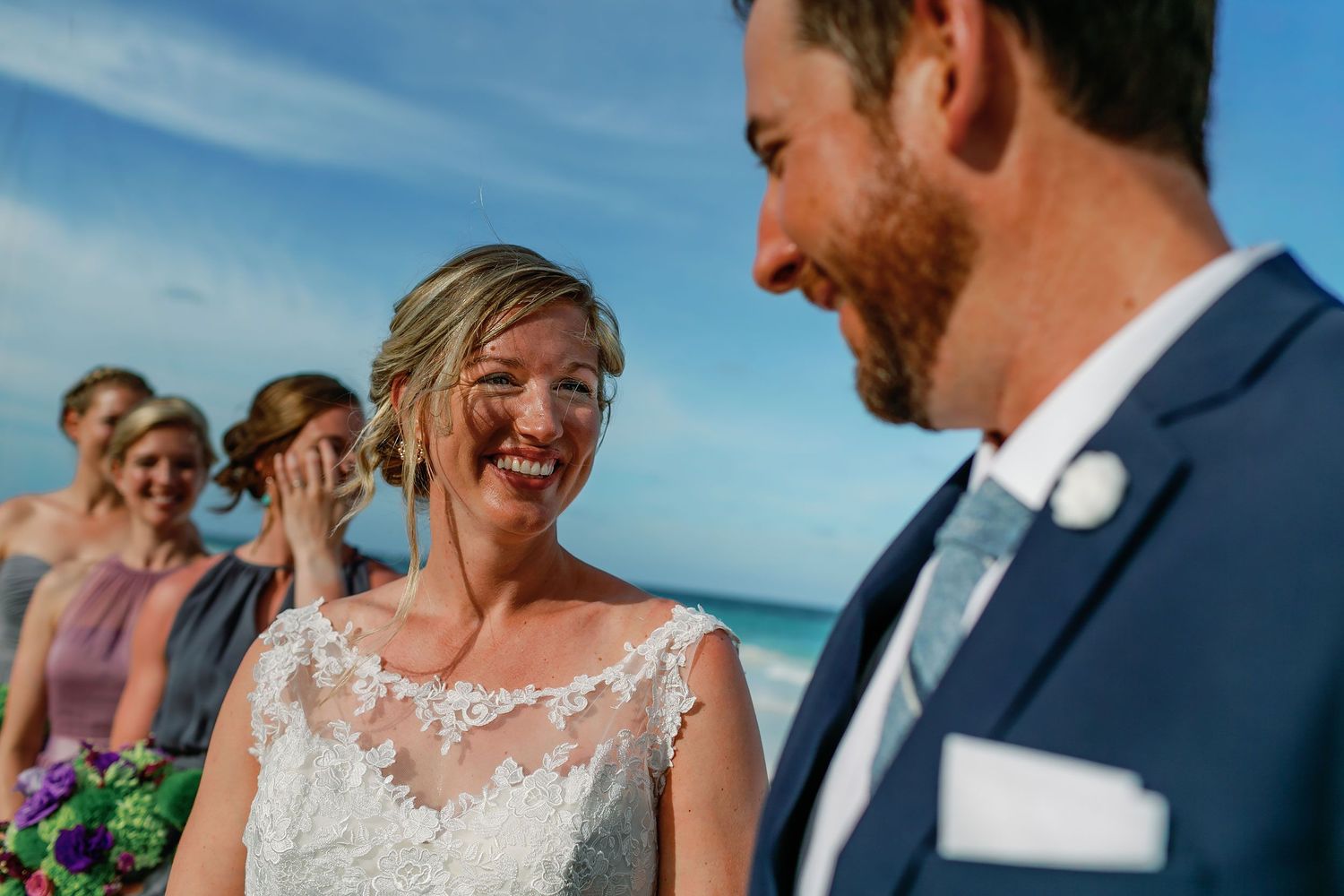 Ashley smiles at Matt during their Caribbean beach wedding ceremony in Tulum.