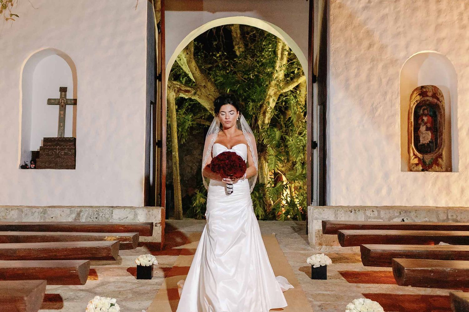 Bride walking down aisle at San Francisco de Asís Chapel, Xcaret Riviera Maya—romantic Catholic wedding venue near Cancun
