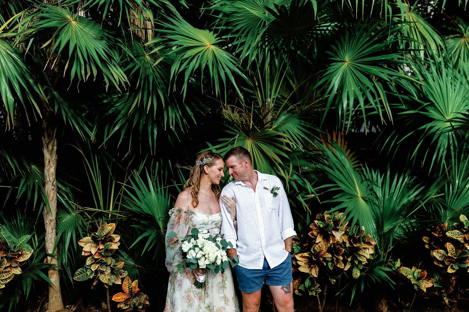Autumn and Brian sharing a quiet moment surrounded by tropical greenery at Dreams Sapphire in Puerto Morelos.