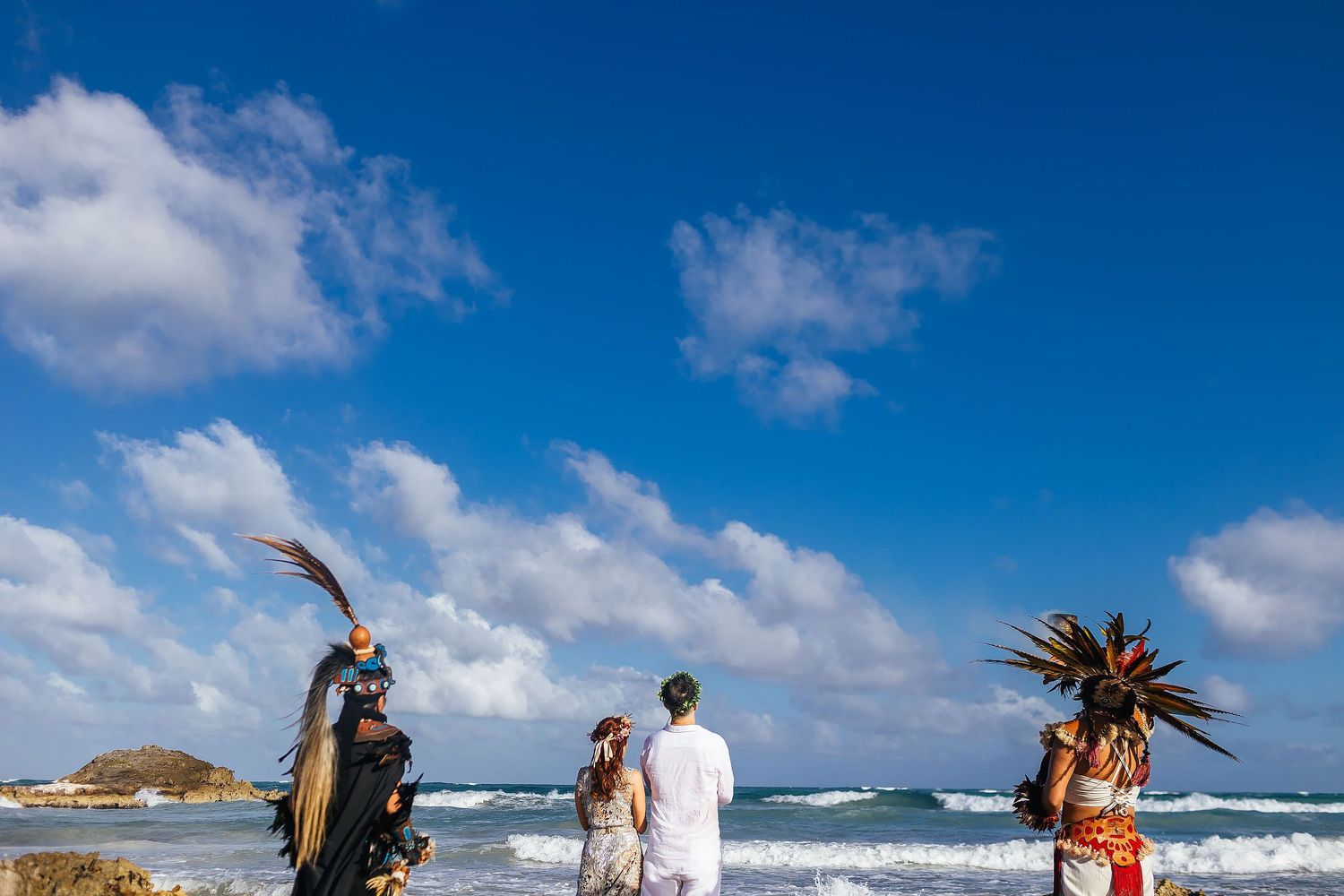 Sarah and Evish face the Caribbean Sea during their Tulum beach ceremony