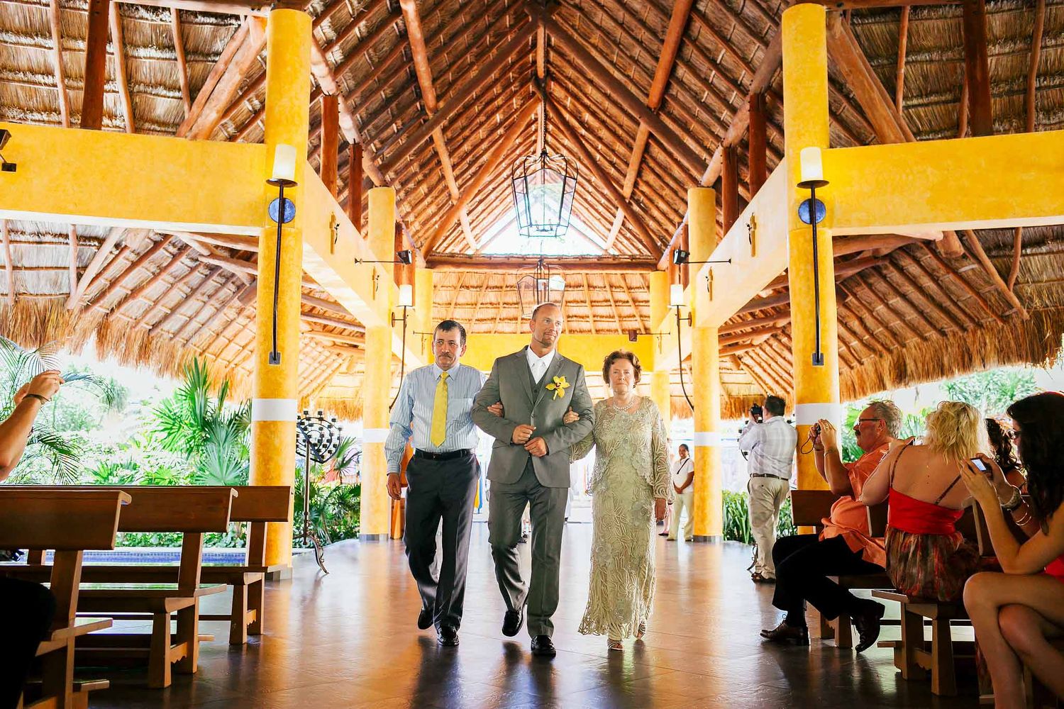 Groom walking down aisle at Our Lady of Guadalupe Chapel Barceló Riviera Maya during Catholic wedding ceremony