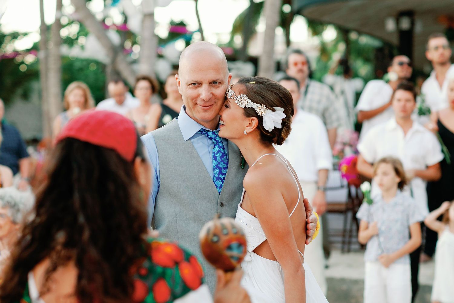Juliana and Tom embrace after their beach wedding ceremony.