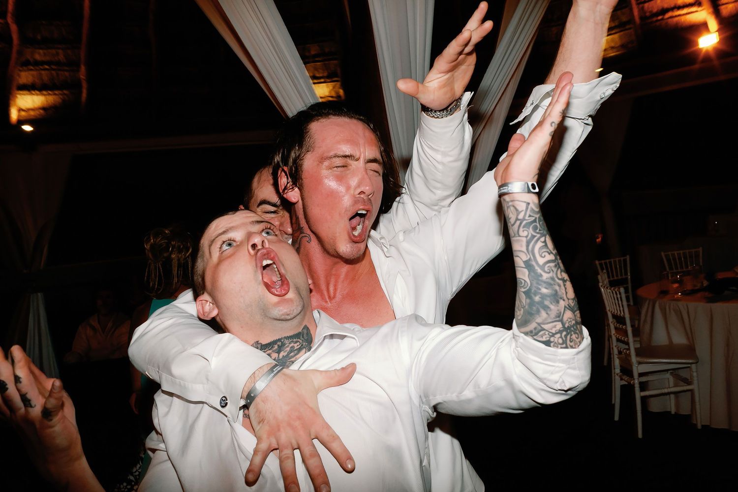 Scott and his friends singing together on the wedding dance floor