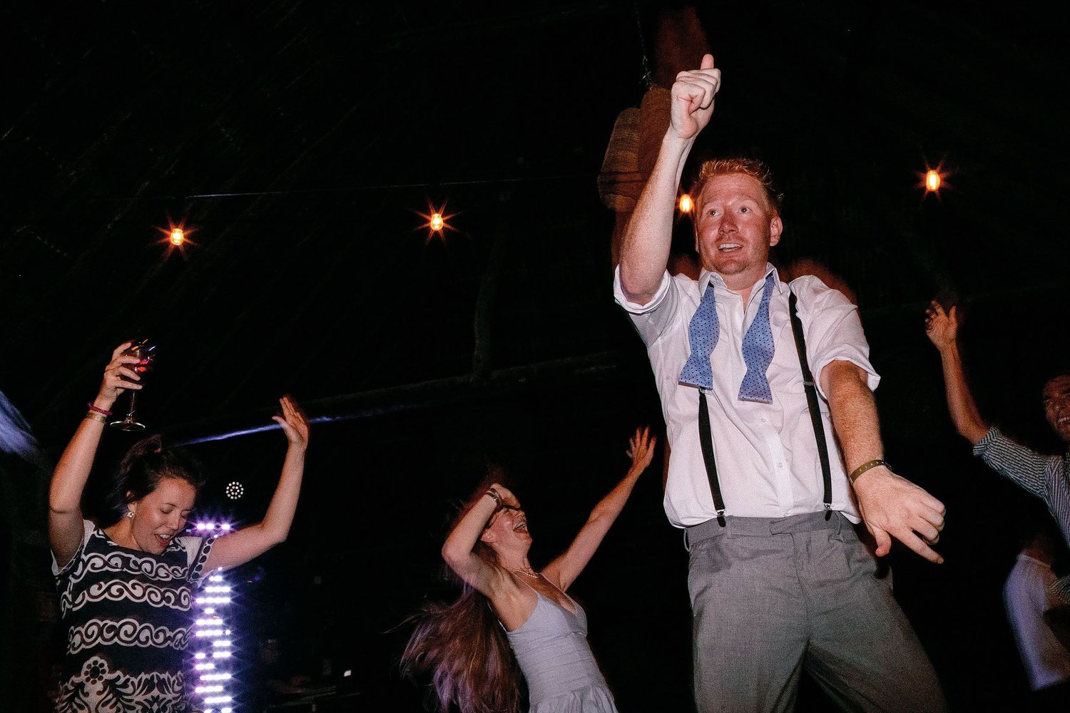 Alan celebrating on the dance floor with wedding guests during the reception at a private Riviera Maya venue.