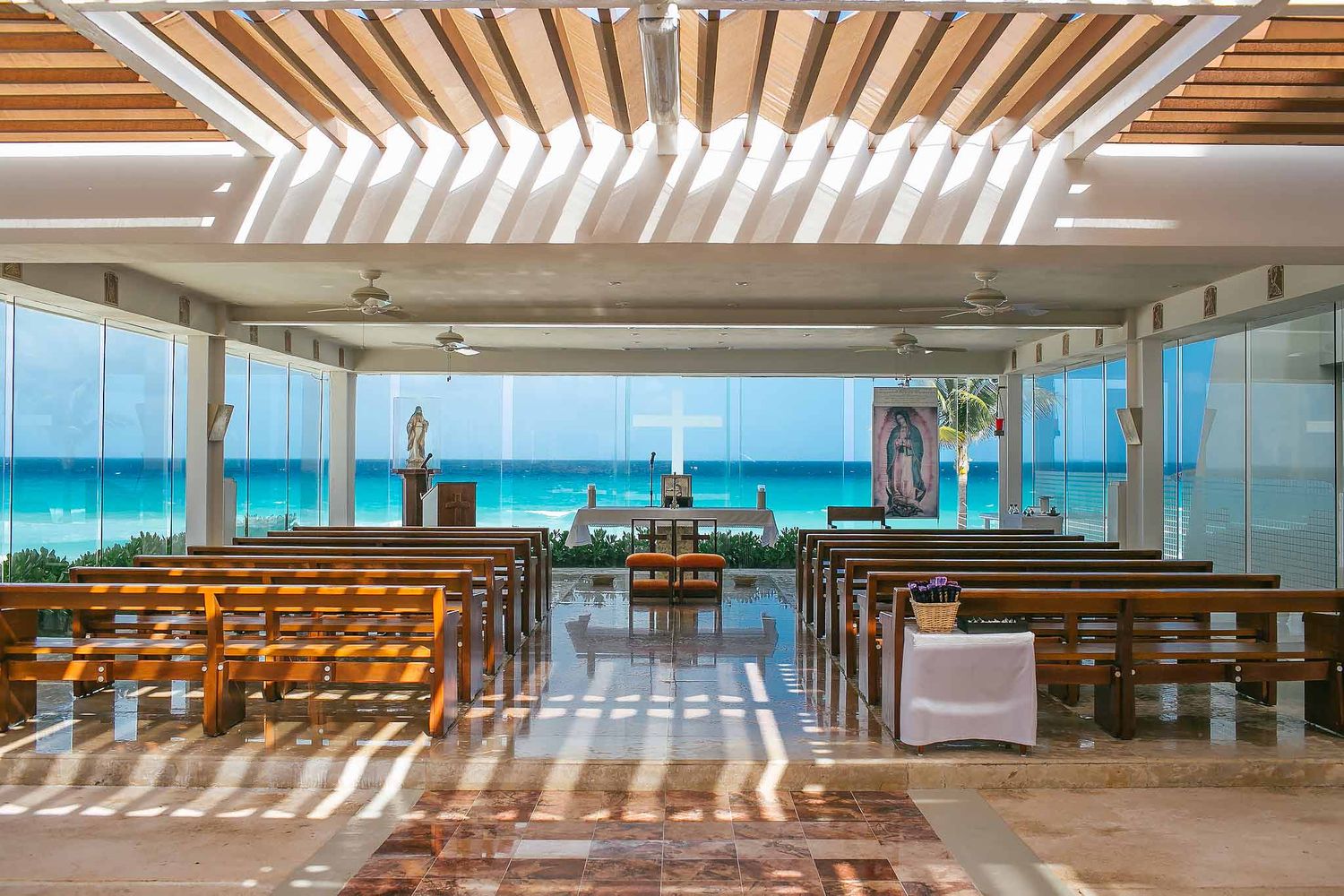 Sunscape Cancun Catholic wedding chapel interior with ocean view altar, glass walls and tropical beach ceremony setting