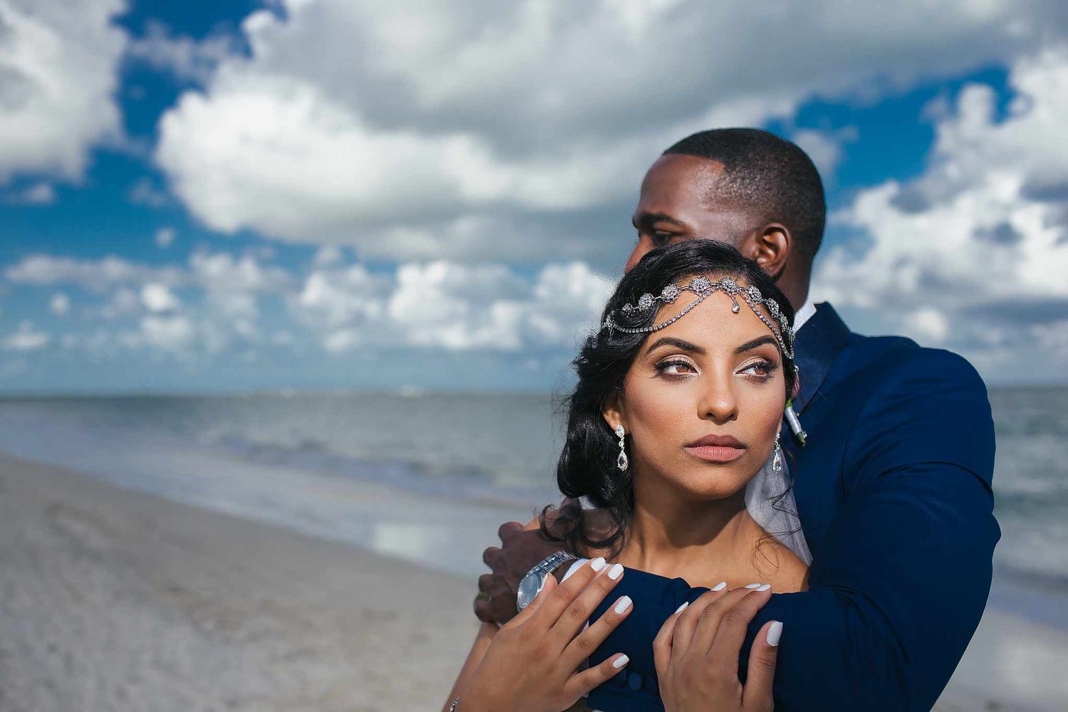Elegant bride and groom portrait on the beach in Playa del Carmen with ocean backdrop, destination wedding photography